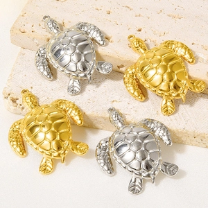 Macro detail of turtle-shaped 304 stainless steel pendants in gold and silver finish