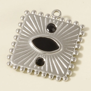 Macro view of vintage silver steel pendant featuring black enamel inlay and radial engraving