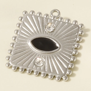 Macro view of square stainless steel evil eye pendant with crystal and radial texture