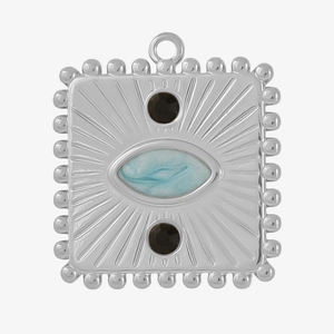 Macro detail of vintage silver square pendant with sunburst texture and blue stone inlay