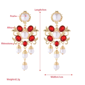 Vintage floral pearl tassel earrings with rhinestones and red gems on a golden base