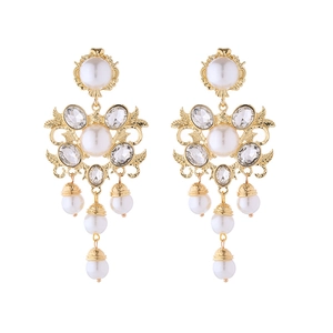 Macro detail of Baroque pearl tassel earrings with gold floral patterns and rhinestones