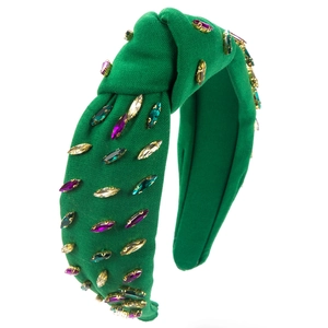 Detail of green knot headband with hand-sewn colorful rhinestones in gold settings