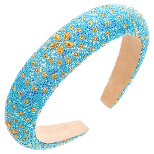 Close-up of blue padded headband with gold rhinestones and sparkling floral details