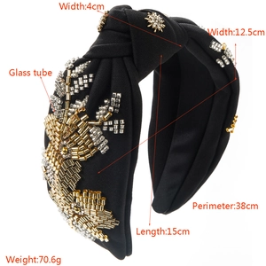 Detail of black fabric headband showing hand-sewn gold and silver glass tube beads