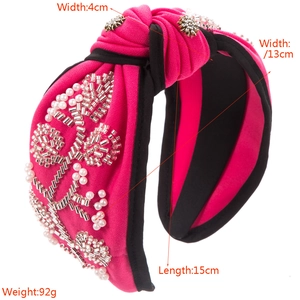 Hot pink wide knotted headband with hand-sewn pearls and floral rhinestone accents