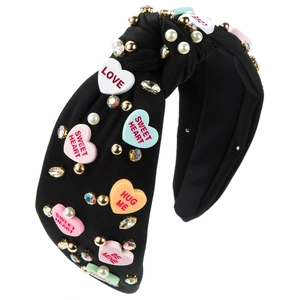 Detail of black knotted headband with colorful heart candy charms, pearls and crystals