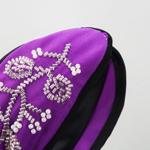 Purple knotted headband with hand-sewn pearls and floral beadwork for elegant styling