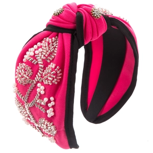 Close-up of fuchsia knotted headband with hand-sewn pearls and sparkling rhinestones