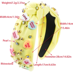 Yellow knotted headband with heart decorations, pearls, and crystals for a sweet style