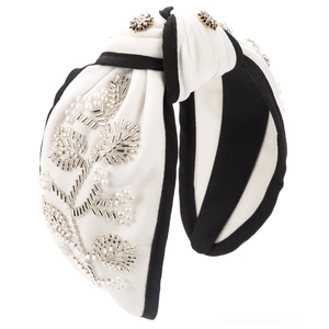Detail of hand-sewn beads and pearls floral pattern on a knotted wide headband