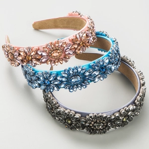 Detailed view of three crystal headbands in pink, blue, and gray with velvet lining
