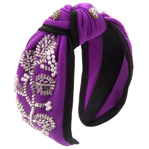 Close-up of purple knotted headband with hand-sewn pearls and silver beads detailing