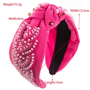 Pink knotted headband with hand-sewn pearls and floral beadwork for elegant styling
