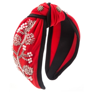 Close-up of red knotted headband with pearl floral beadwork and rhinestone accents