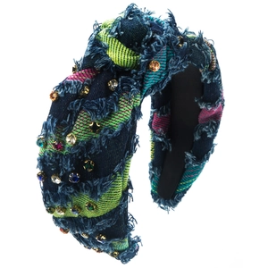 Detail of a denim knotted headband with colorful rhinestones and plaid fabric texture