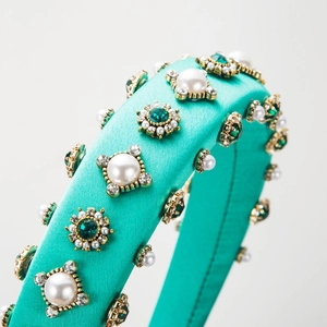 Baroque style sponge headband with teal satin, pearls and rhinestones on grey background