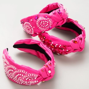 Detail of three rose red knotted headbands with handmade beads and crystal floral sequins