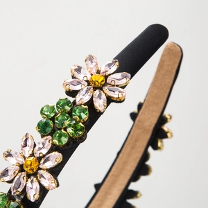 Fashionable floral headband with sparkling crystal flowers on a black satin band