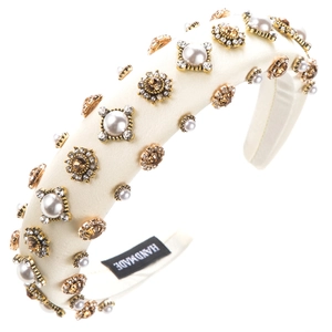 Detailed macro of baroque headband with pearls and rhinestones on satin fabric
