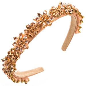 Detail of a pink padded headband with intricate champagne crystal flower embroidery