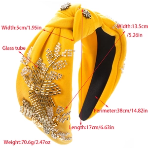 Yellow knotted headband with hand-sewn silver glass beads and floral fabric details