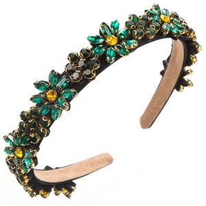 Detail of floral headband with emerald green crystals and yellow center rhinestones