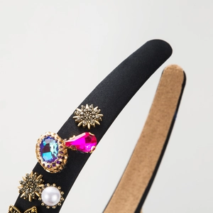 Retro black satin headband with blue and pink gemstones, pearls, and gold star accents