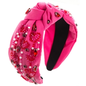 Detail of rose red knotted headband with hand-sewn beads, pearls, and rhinestones