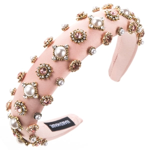 Close-up of handmade pink padded headband with vintage pearls and sparkling rhinestones