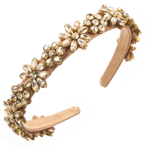Detail of champagne satin headband featuring shimmering rhinestone flower embellishments