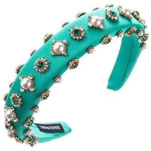 Detailed macro of Baroque sponge headband with emerald crystals and white pearls
