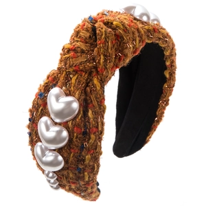 Detail of tweed braided headband with golden threads and heart-shaped pearls