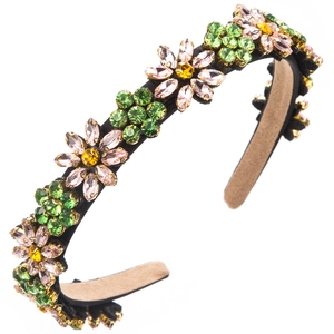 Macro detail showing pink rhinestone petals and green leaves on the floral headband