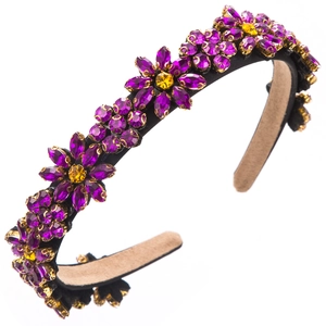Luxurious purple floral headband with rhinestone crystal flowers on a black base