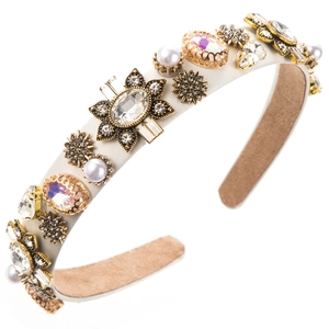 Macro detail of vintage baroque headband featuring crystal flowers and pearl embellishments