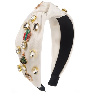 Detail of white velvet Christmas headband with rhinestones and enamel festive charms