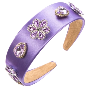 Detailed side view of purple baroque headband with floral rhinestones on satin fabric