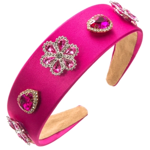 Pink baroque satin headband with rhinestone floral embellishments on a white background