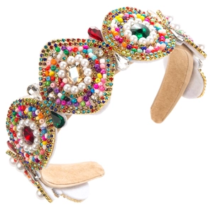 Detailed side view of Baroque headband featuring colorful crystals and pearls on beige velvet