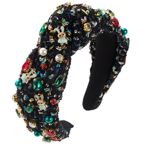 Detailed view of tweed knotted headband featuring multi-color rhinestones and blue bunny charms