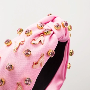 Pink satin headband featuring crystal rhinestones and enamel high heel heart charms