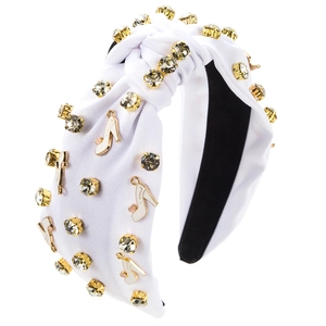 Close-up of knotted white headband with champagne rhinestones and enamel high heel charms