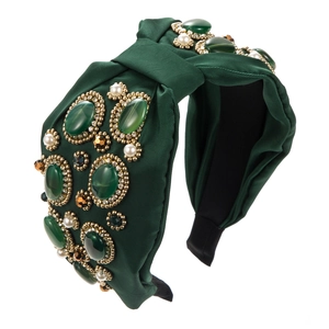 Detail of bohemian green fabric headband with inlaid colorful gemstones and pearls