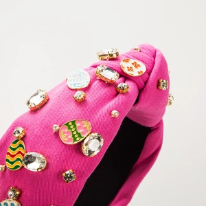 Pink knotted wide headband with sparkling rhinestones and floral enamel egg ornaments