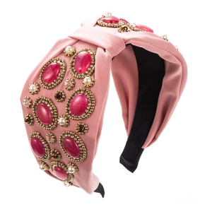 Bohemian pink fabric headband with vintage colorful gemstones and pearls on white background