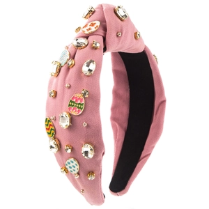 Detail of pink fabric headband featuring rhinestones and colorful enamel Easter egg charms
