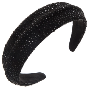 Macro shot of padded black headband with dense miniature rhinestones on velvet fabric