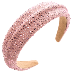 Detail of pink rhinestone headband with velvet texture and sparkling crystals