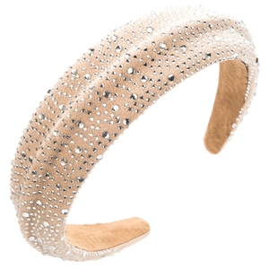Detail of champagne sponge headband featuring dense white rhinestones on soft velvet fabric